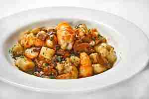 Lobster gnocchi served in a white bowl
