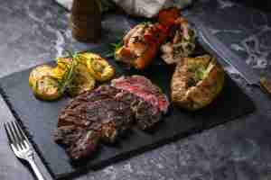 Steak and lobster being served on a plate at a restraunt